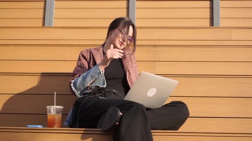 Woman Working on Laptop Outdoors