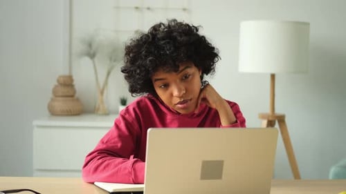 Young Adult Working on Laptop at Home