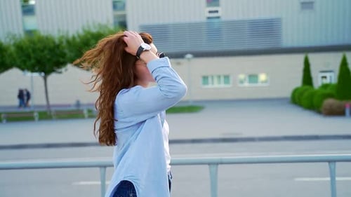 Young stylish girl hipster tourist runs a suitcase is late for departure to the airport or bus