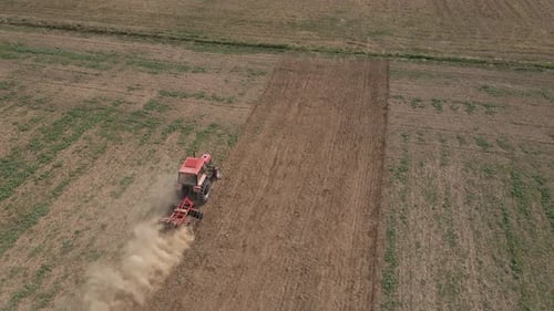Small Tractor Cultivating Soil at Agricultural Field Aerial View