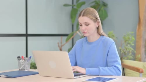 Woman Working on Laptop at Desk Indoors