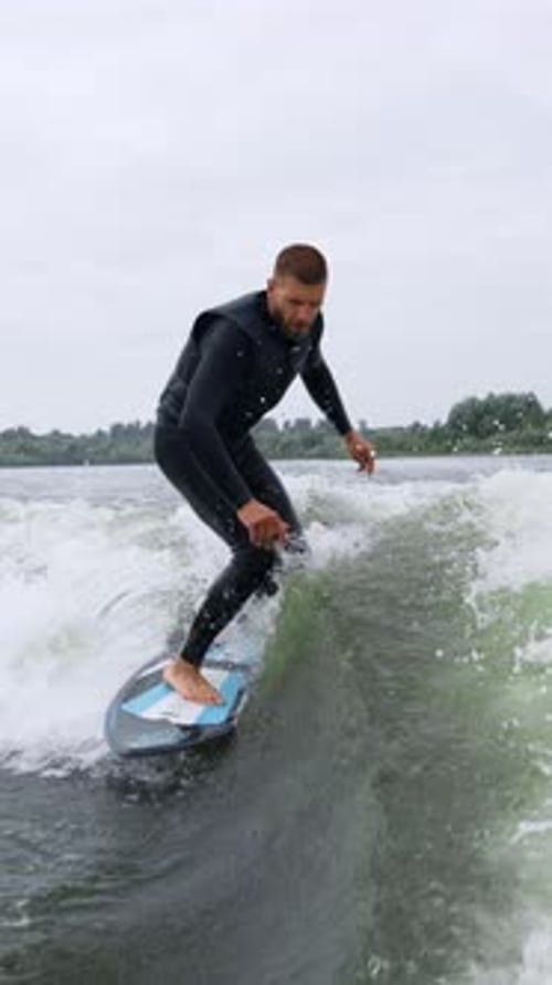 Dynamic Surfing Adventure A Skilled Surfer Navigates the Choppy Waters with Precision Showcasing