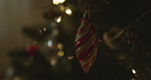 Happy New Year Christmas Tree Decorates on Branch Snow on Background Bokeh of Side Flickering Light