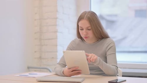 Woman using Tablet in Office Environment