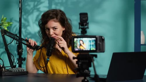 Woman Broadcasting Live Online Using Microphone and Camera