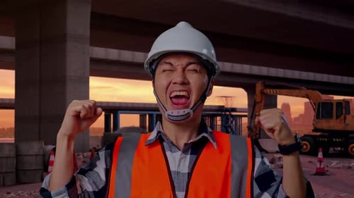 Close Up Of Asian Male Engineer Screaming Goal Celebrating Working At Building Site