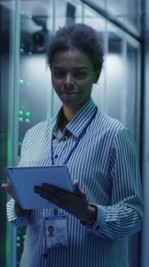 Woman with Tablet Smiling in Server Room