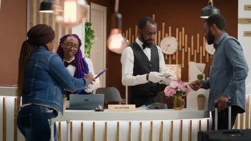 Hotel Receptionists Assisting Guests at the Front Desk