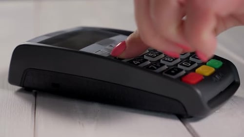 Finger Entering Pin Number on Credit Card Terminal