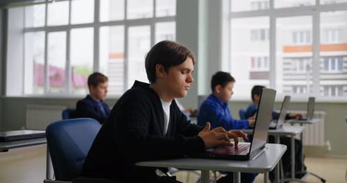 Diverse School Students Boys Working With Laptops In ComputerBased Class WebDesign In School