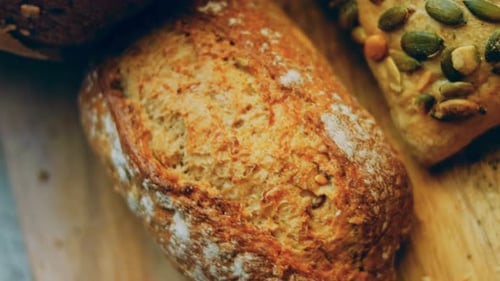 Close-Up of Rustic Bread Rolls on Wooden Board