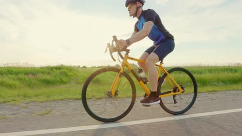Two Men in Sportswear Practicing Cycling on Fresh Air