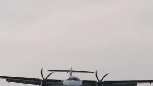 Airplane Coming in for Landing in Cloudy Sky