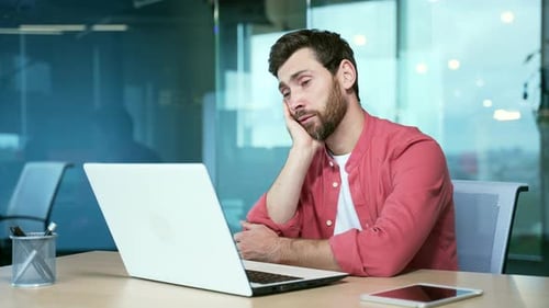 bored men in the office Sleeping sleepy yawning boredom at workplace indoors. Tired man. Exhausted