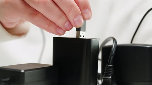 Hands Plug USB Cables into Black Charger