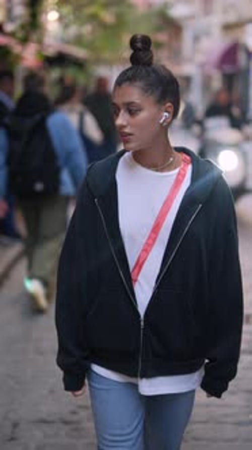 Casual Urban Walk with Headphones Enjoying the Vibrant Atmosphere of the City Streets