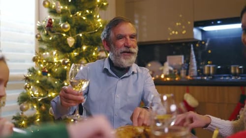 Family at Table Cheers at Christmas Dinner