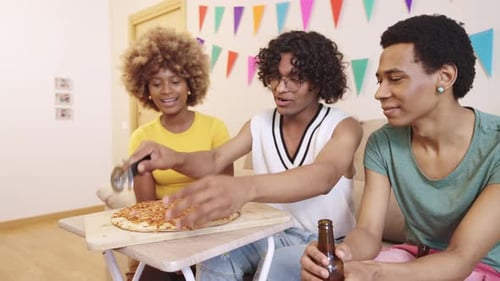 Friends Enjoying Pizza at a Birthday Party