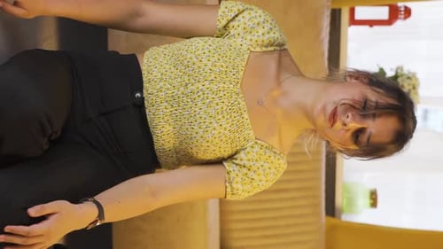 Young Brunette Woman Sitting, Touching Face