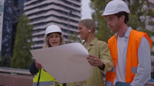 Construction Team Reviewing Plans on City Building Site