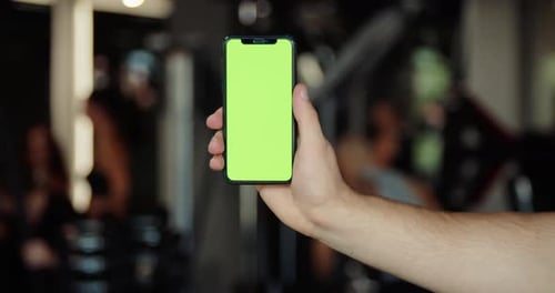Fitness Man Using Green Screen Smart Phone at Home Man Preparing for Workout Using Smart Phone Man