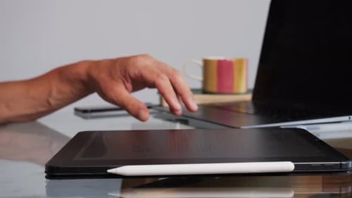 Man Using Tablet and Stylus Pen at Desk
