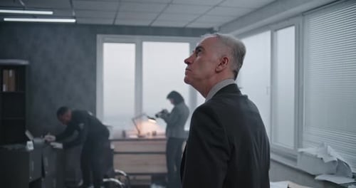 Office Robbery Case Medium Close Up of Male Detective Examining Crime Scene