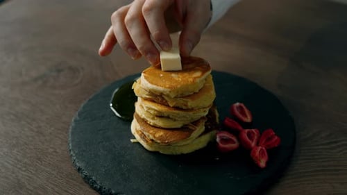 Pancakes with strawberries and honey and cheese