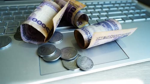 Money and Technology: Currency on Laptop Keyboard