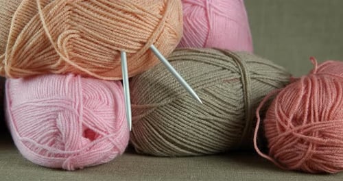 Yarns and needles on table.
