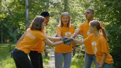 Group of Volunteers Joining Hands in Unity