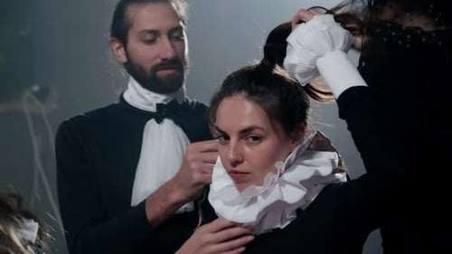Elegant Adults in Period Costumes Getting Ready