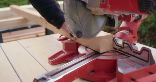 Lumber being cut with chop saw