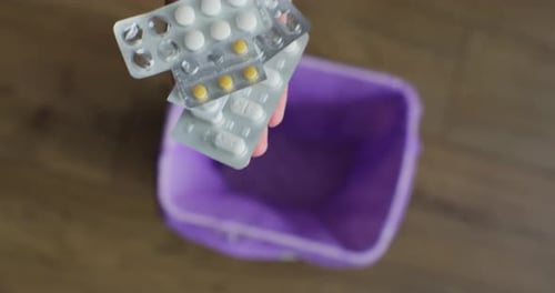 Woman Throwing Out Pills in the Trash Closeup The Concept of the Healthcare Industry