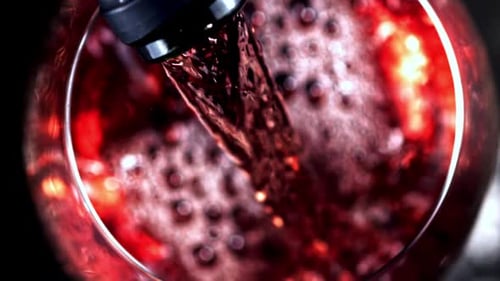 Pouring Red Wine into a Wine Glass