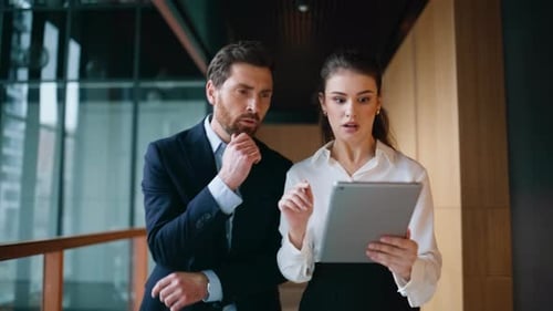 Frustrated Colleagues Looking Tablet Walking Business Center Corridor Closeup
