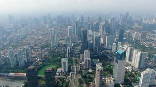 Jakarta city center and skyscrapers, Indonesia. Aerial forward