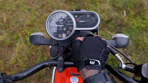 B-Roll Close-Up of Motorcycle Key Turning On in Rural Cambodia