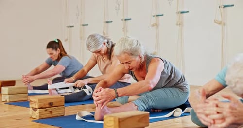 Exercise, yoga and senior women stretching in class for wellness, healthy body and fitness on floor