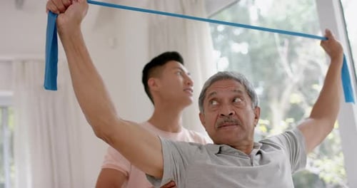 Senior Man Assisted with Physical Therapy Exercise