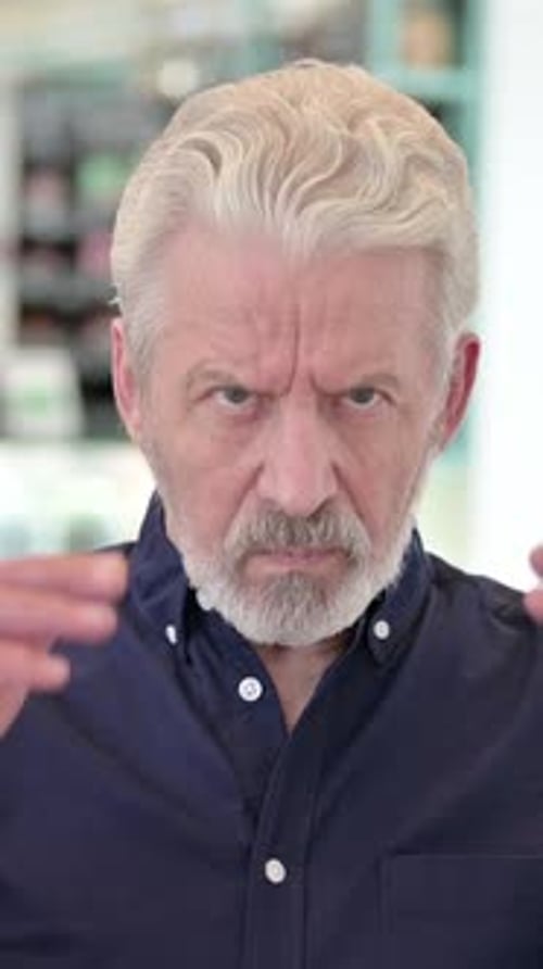 Senior Man Experiencing Headache and Touching Temples