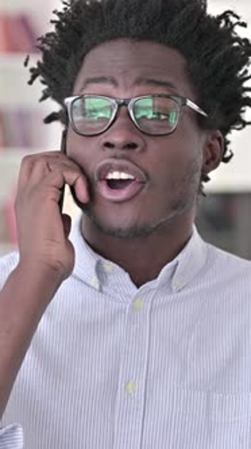 Young Adult Man Talking on Smartphone