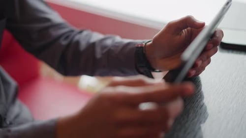 Hands Holding a Tablet Device Indoors