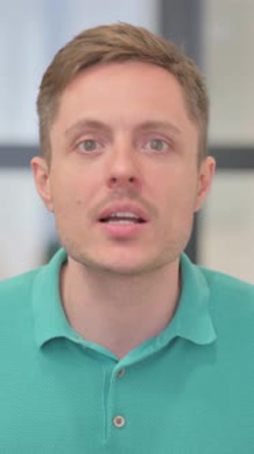 Man in Green Shirt Talking in Home Interior