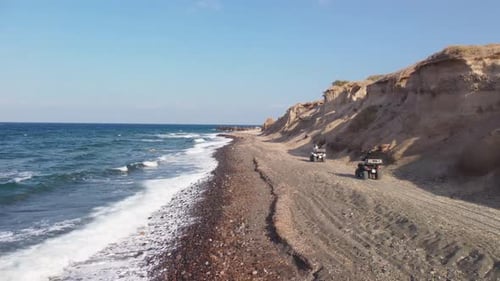 Off-road ATV Excursion Adventure in Santorini Greece. Riding Along a Sandy Beach Side With Ocean Wav