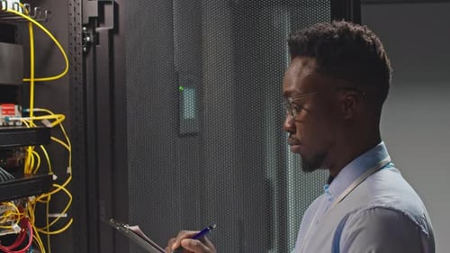 Young Adult Inspects Data Servers