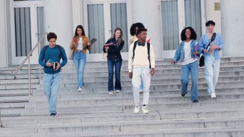 Diverse group of happy students leaving college