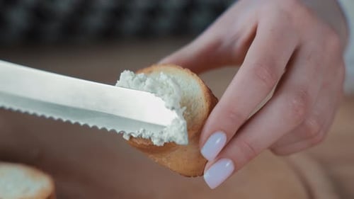 Cream Cheese Spreading on Bread Slice Close Up