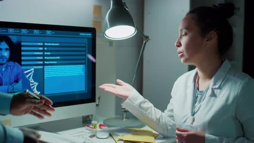 Scientists Reviewing Criminal Profile in a Lab