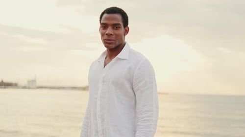 Man on Beach at Sunset Enjoying the View